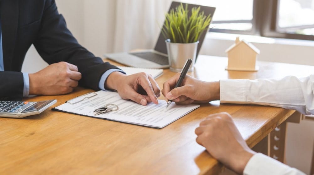 realtor pointing to contract for signature